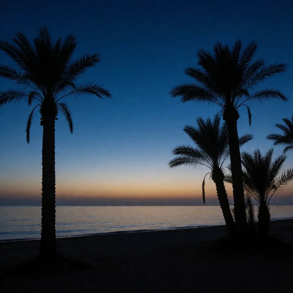 Palm silhouettes against a cobalt twilight sky on the Egyptian coast